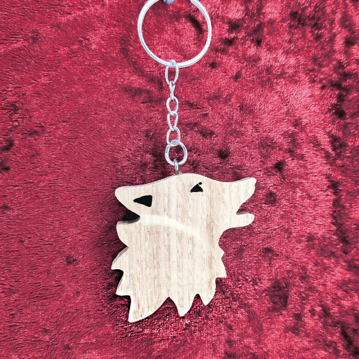 Voici un joli porte-clés d’un loup en bois noble